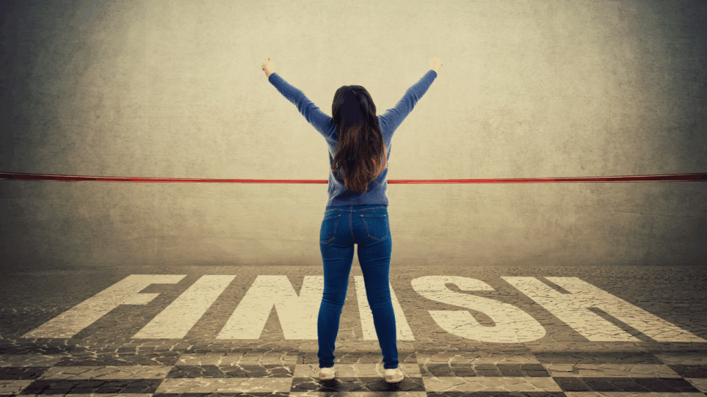 ゴールラインの前で両手を上げる女性